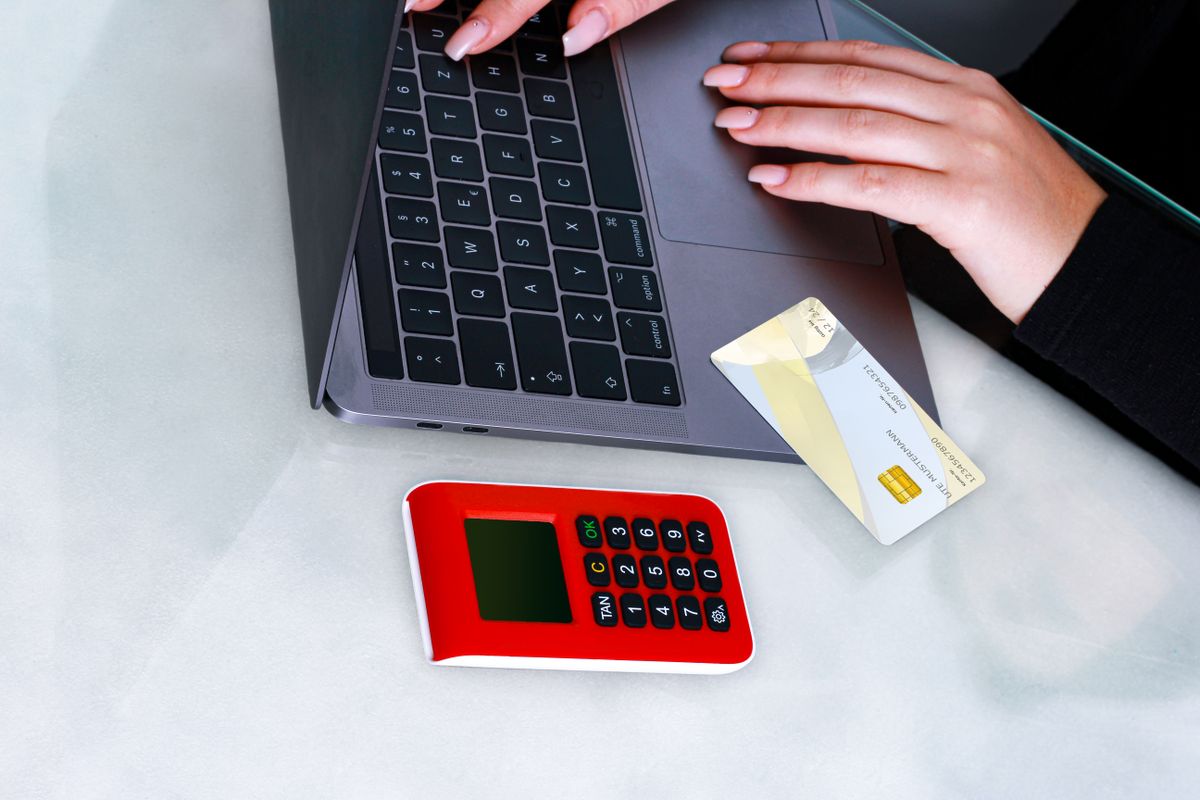 Hands using a laptop with a security device emphasizing secure access and token protection