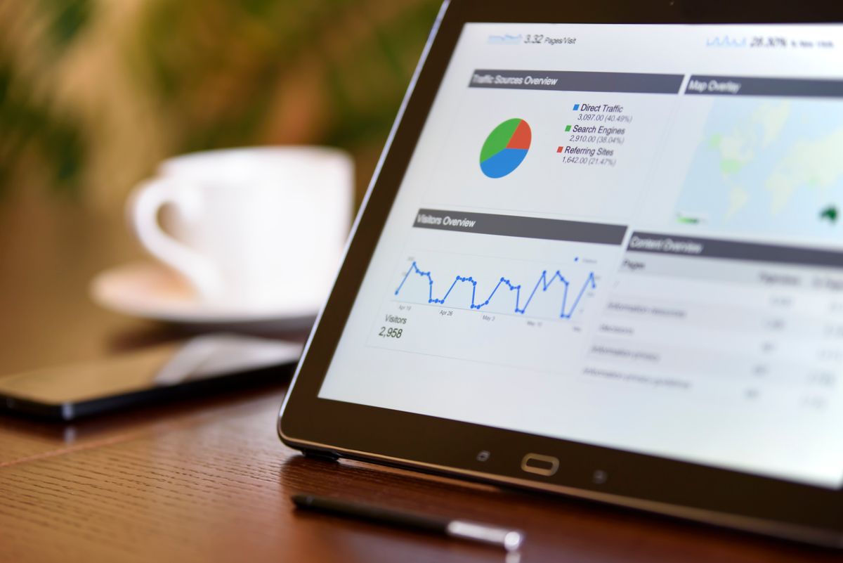 NestJS GraphQL vs REST implementation — tablet displaying analytics charts on desk representing dashboard data relationships