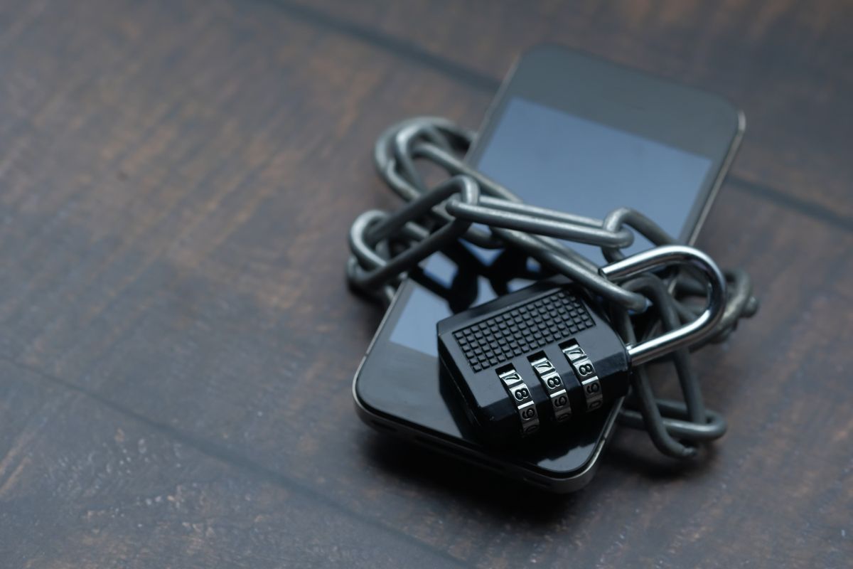 Smartphone wrapped in a chain with a padlock representing API idempotency and secure retry patterns