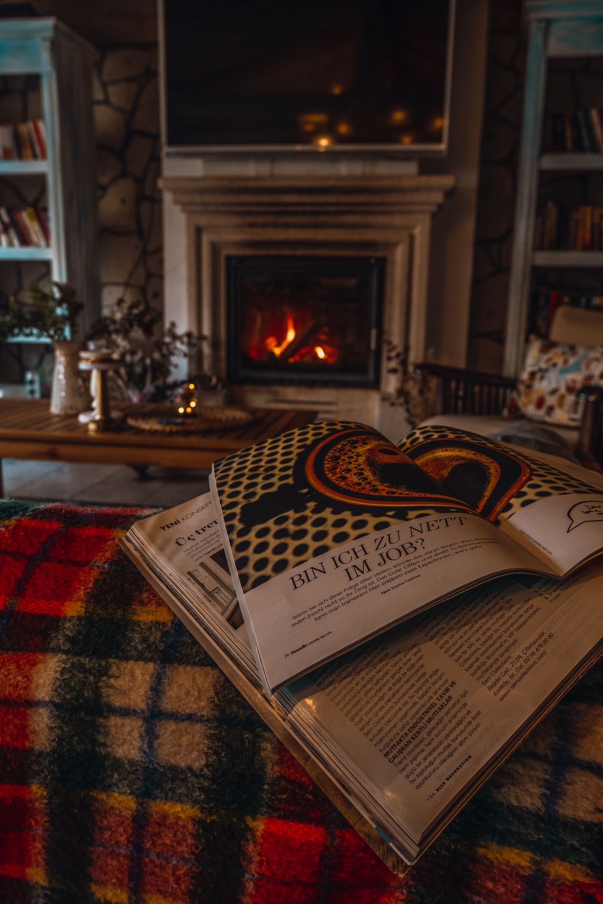 A cozy living room with a lit fireplace and a warm blanket on the sofa, representing provisioned concurrency keeping Lambda instances warm at an ongoing cost