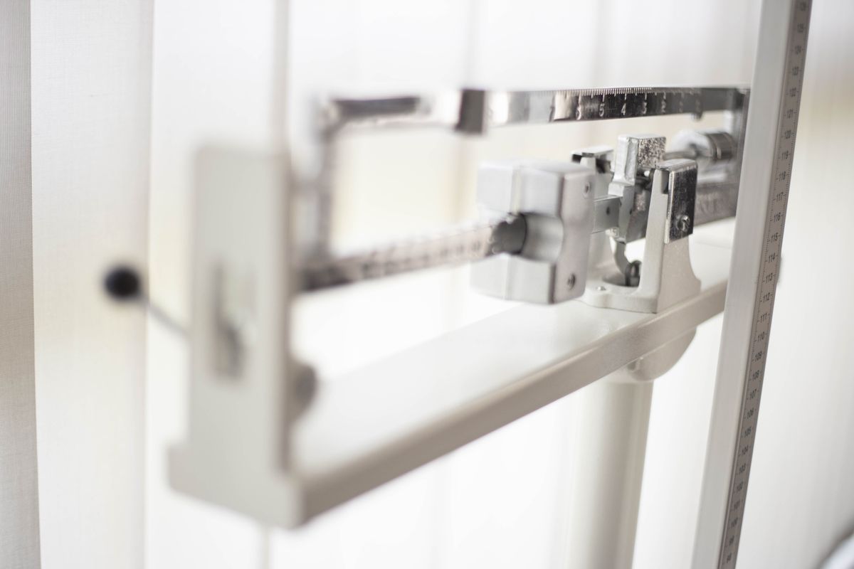 A classic mechanical balance scale, representing the file size limit your architecture needs to route around instead of fight