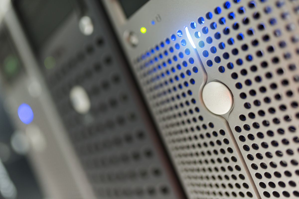 Server rack with green and blue indicator lights representing load balancing and traffic switching
