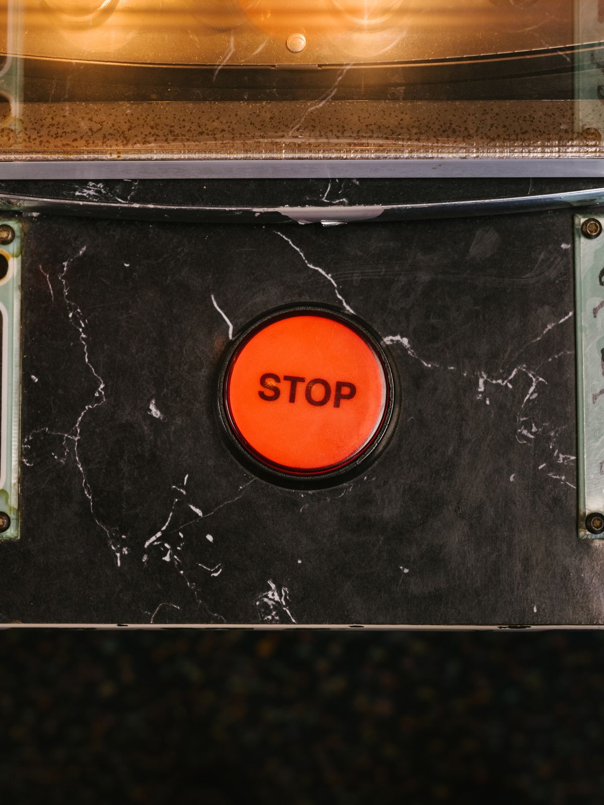 A red emergency stop button on industrial machinery, representing the connection reset Prisma throws when Neon's compute hasn't finished waking up in time