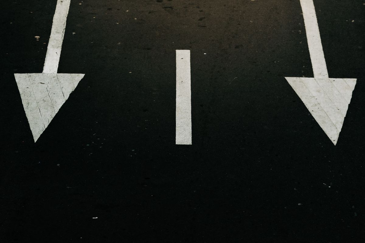 GraphQL vs REST decision for SaaS API — direction arrows on a street symbolizing a technology choice