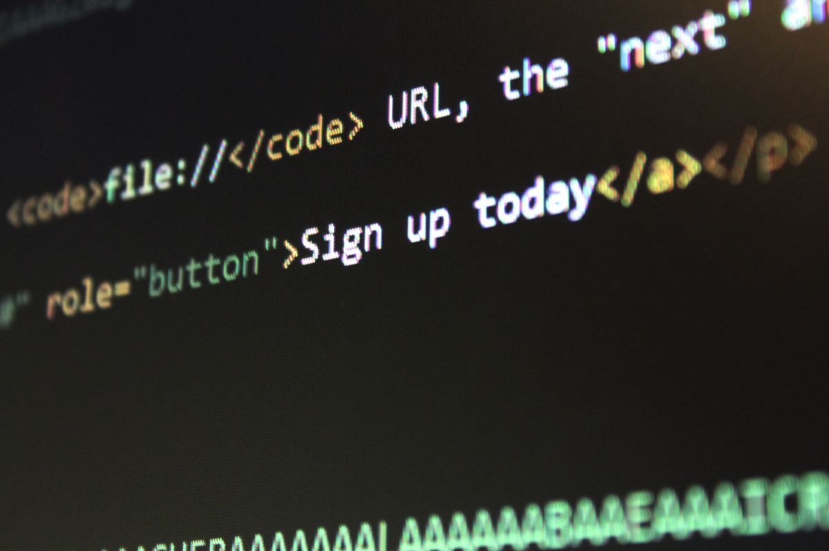 Close-up of computer screen code showing an HTML file:// URL and a button element, representing the exact failing asset path visible in browser developer tools