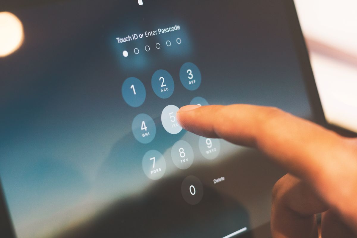 NestJS OAuth2 social login concept — entering a passcode on a phone, representing signing in with an existing provider identity