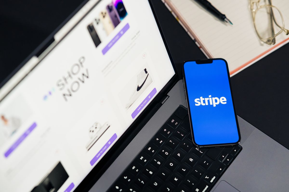 NestJS Stripe webhook handling flow — smartphone displaying Stripe app on a laptop with eCommerce site open, symbolizing payment processing integration