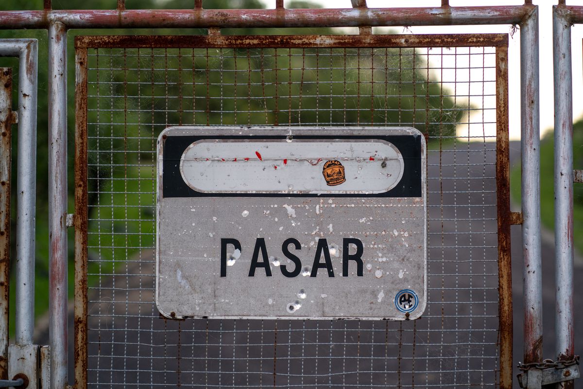 A weathered, rusty 'no entry' gate, representing a middleware check restructured to reject or allow requests without needing a database round-trip at all