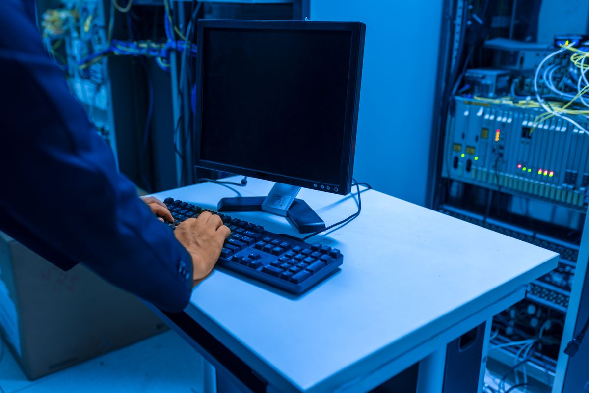An IT professional managing server infrastructure in a data center representing operational deployment of the docker nestjs production multi-stage build optimization