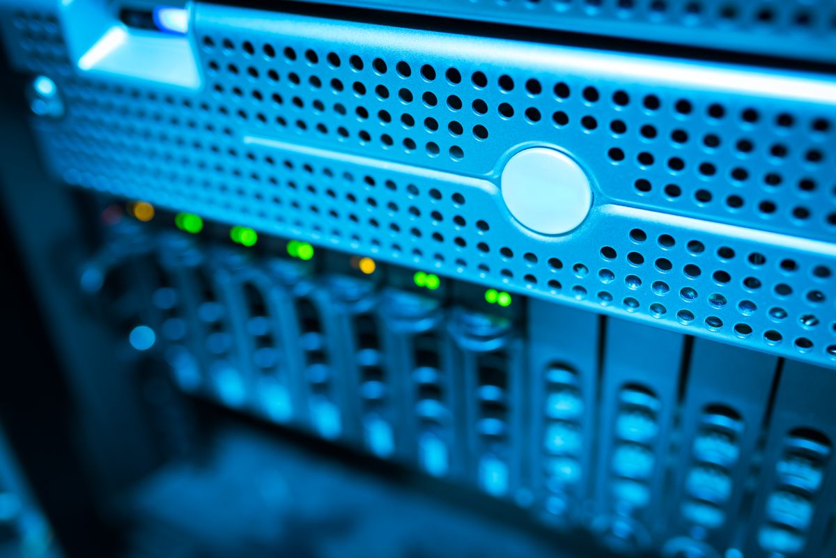Focused view of a modern data server rack with blinking lights representing running production infrastructure for NestJS horizontal scaling