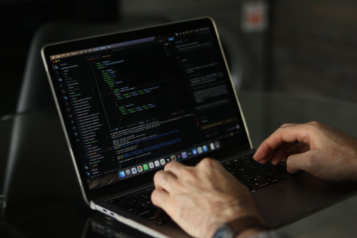 Close-up of hands coding on a laptop representing active nodejs memory leak debugging in production NestJS development