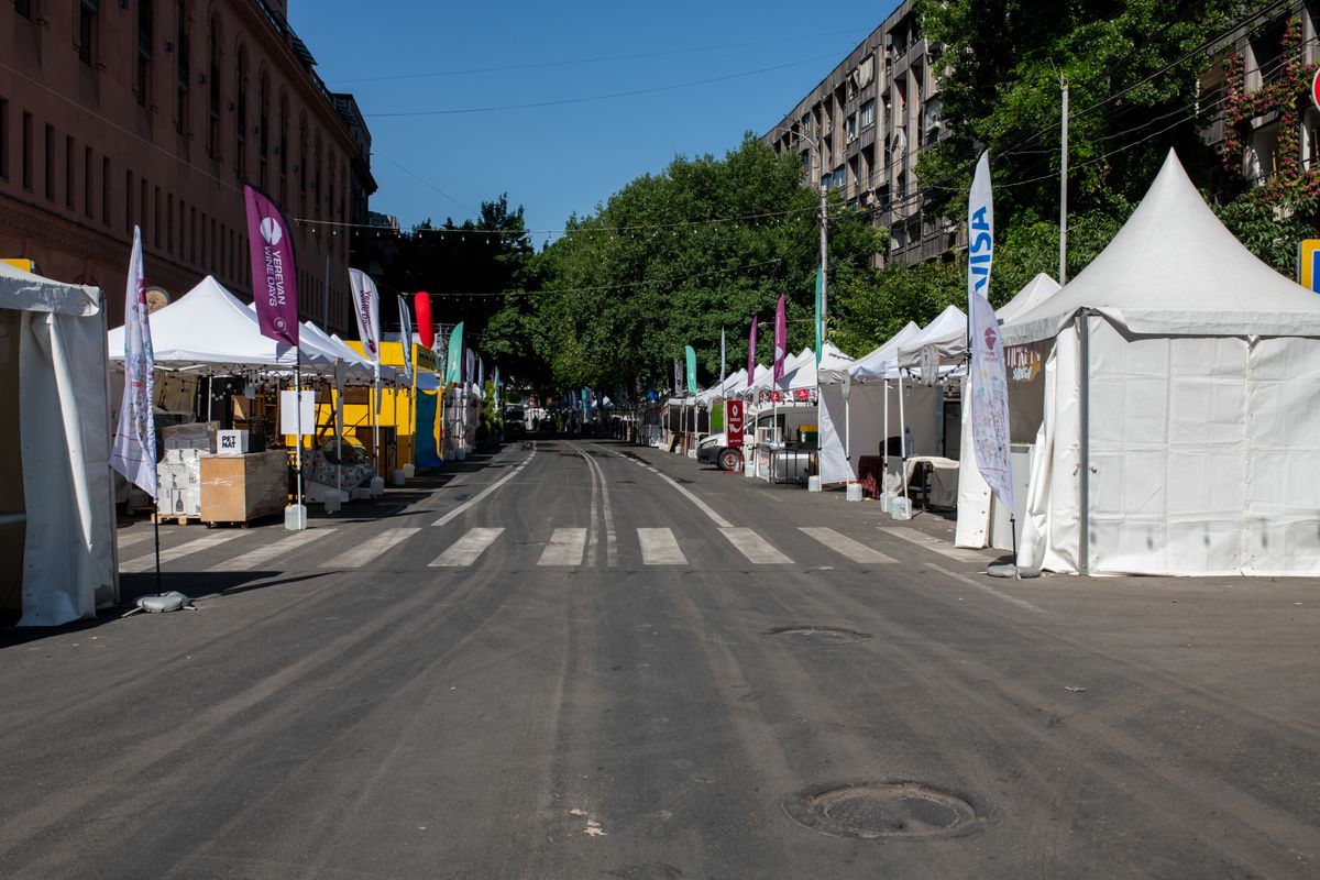 An empty outdoor street market with white tents and no vendors present, representing the ephemeral, per-invocation nature of serverless functions that a persistent dashboard can't rely on