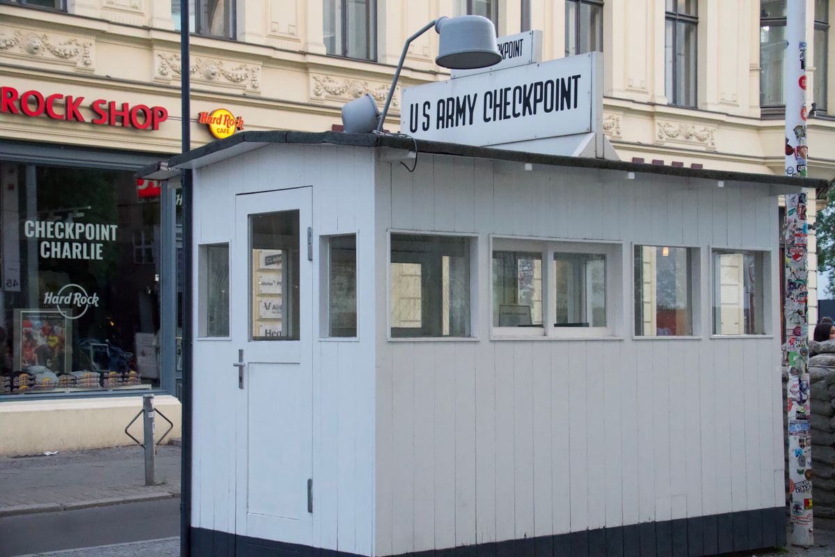 The Checkpoint Charlie guardhouse in Berlin, representing a security group quietly blocking the health check before it ever reaches the container