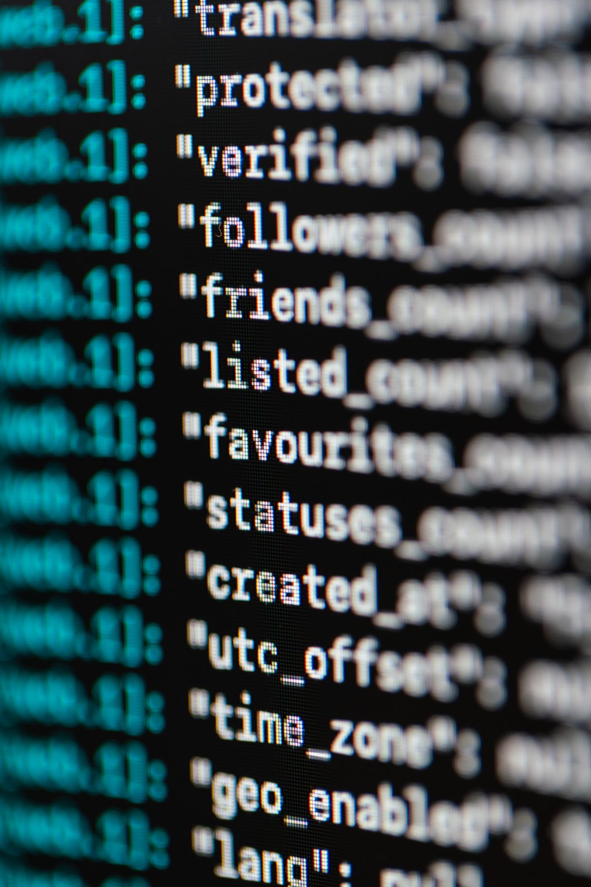 Computer code displayed on a monitor representing PostgreSQL query optimization and database programming