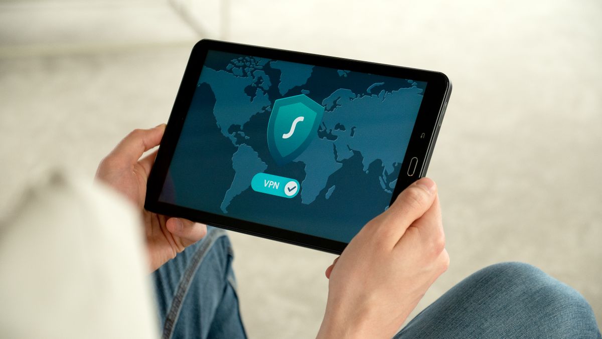 A person holding a tablet displaying a VPN connection screen, representing traffic passing through a proxy layer before reaching your subscription endpoint