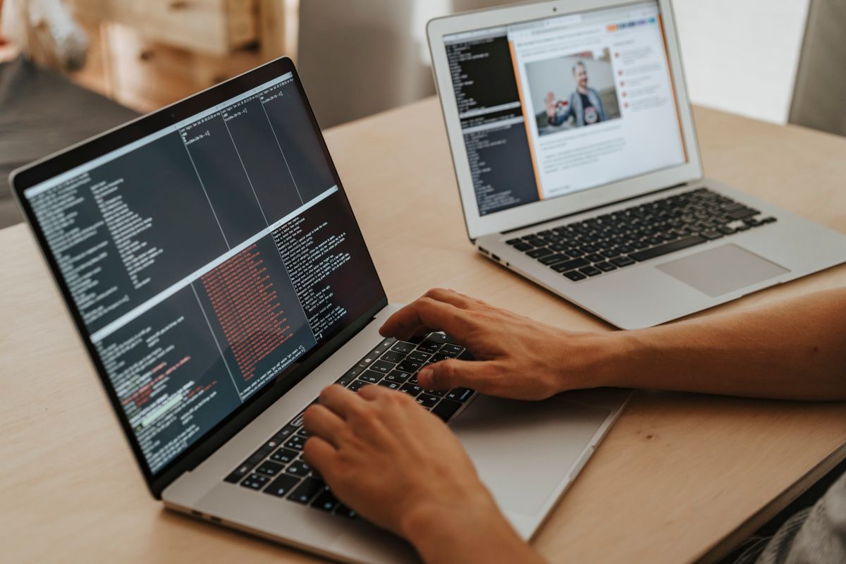 GraphQL vs REST implementation in NestJS — a developer typing code on a laptop
