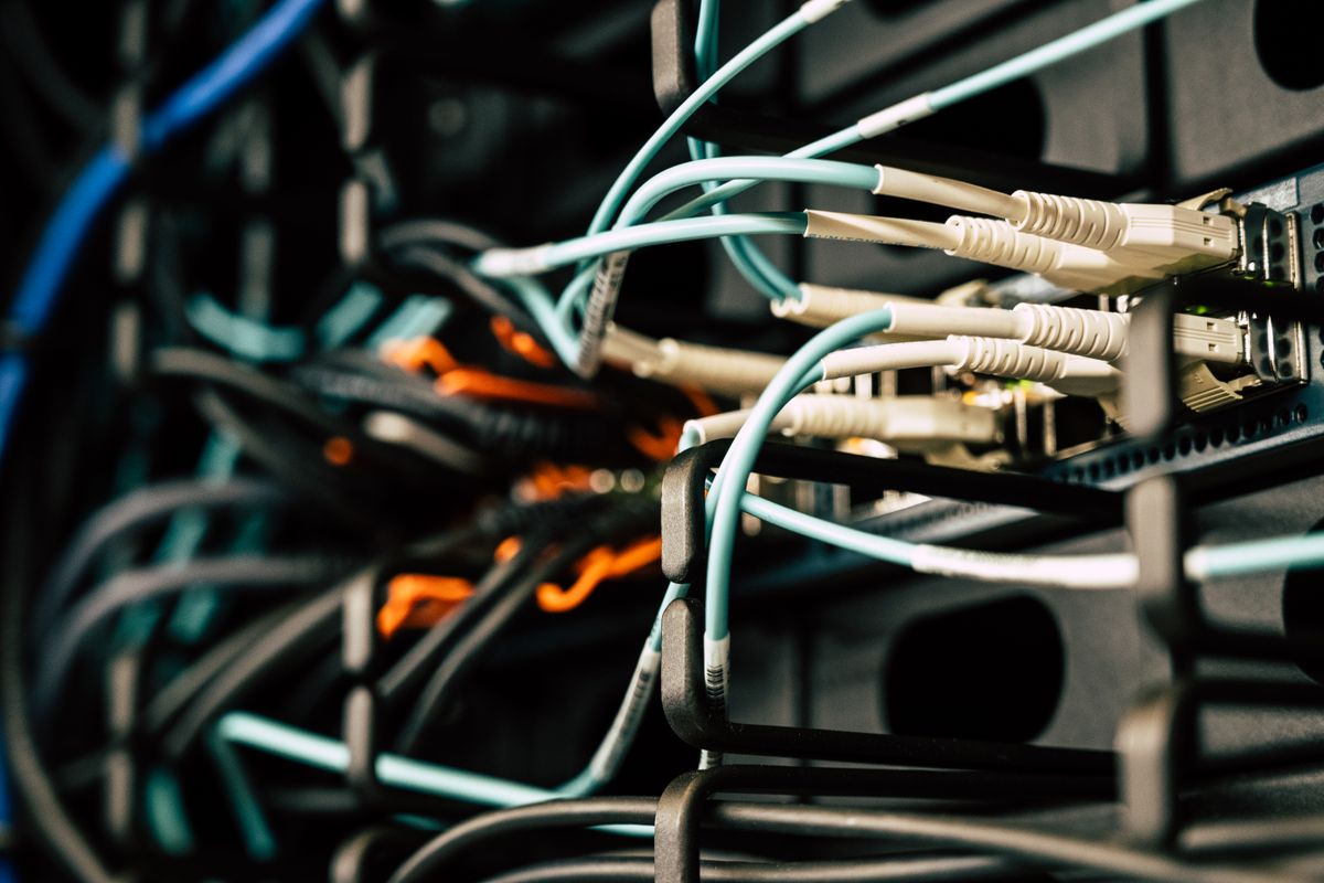 API versioning strategies for handling breaking changes in SaaS — tangled server wires representing complex API version management
