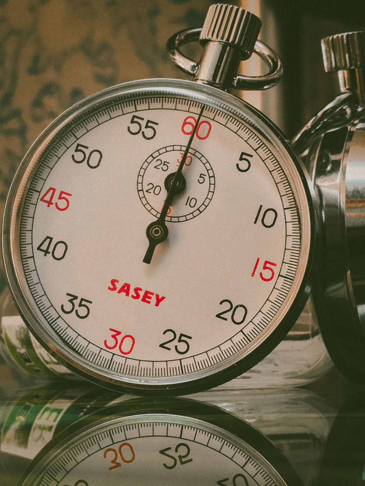 A vintage analog stopwatch, representing the seconds lost to a slow Lambda cold start