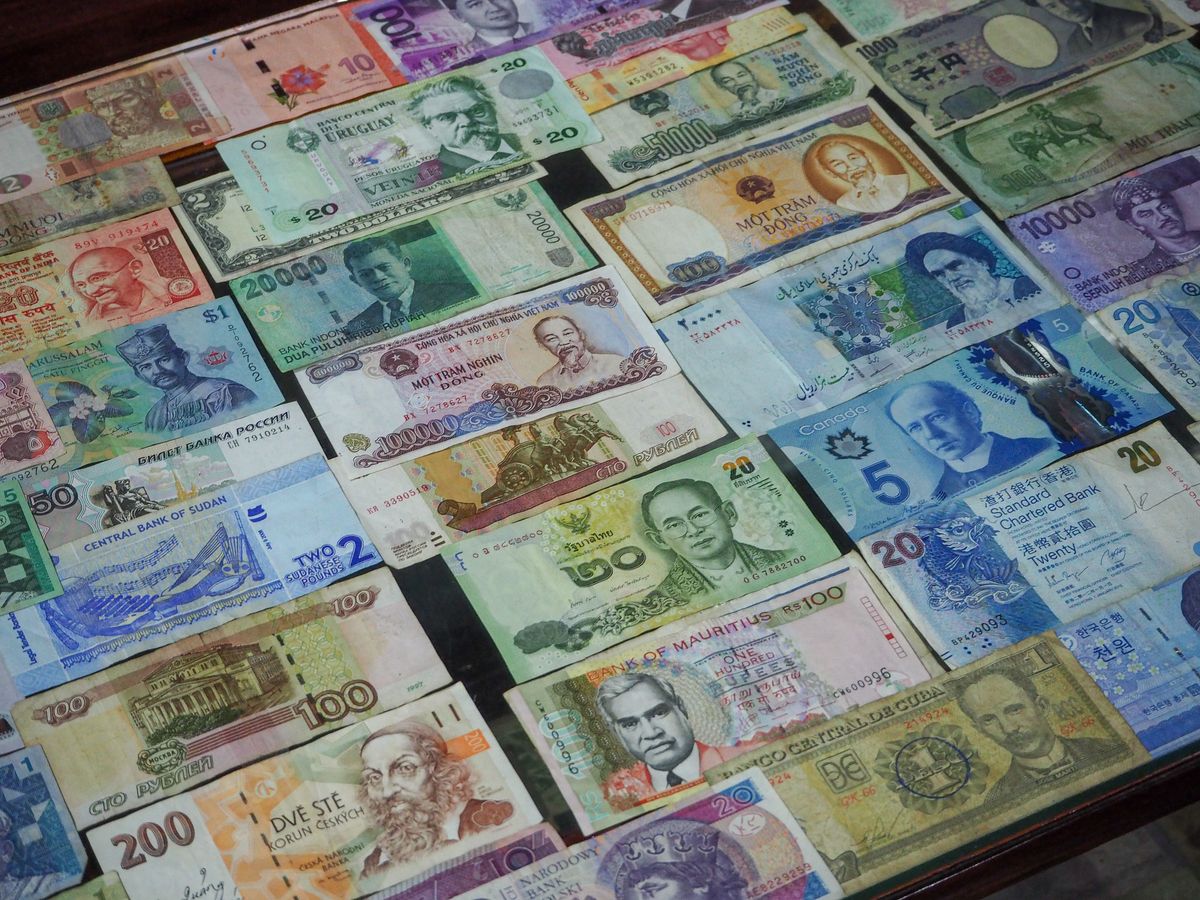 Global currency and finance with colorful banknotes from different countries for multi-currency SaaS