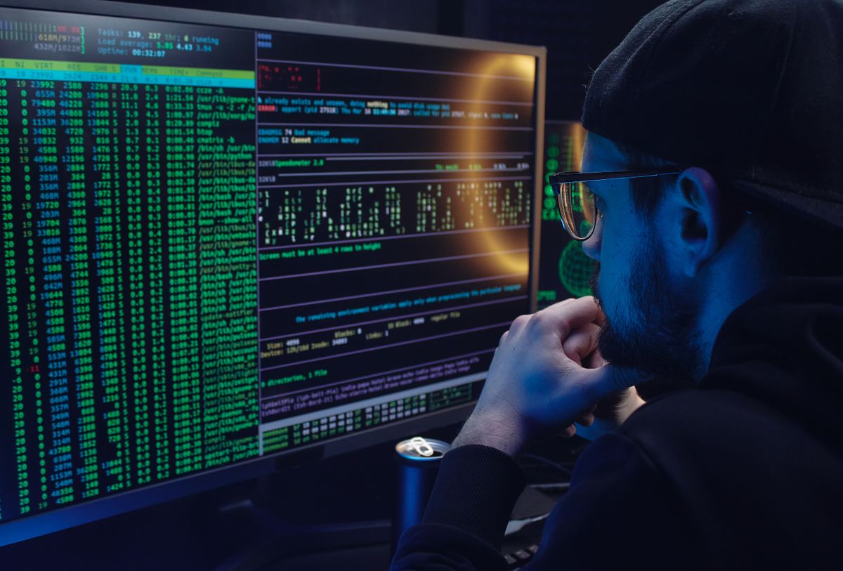 A developer working on dual monitors with code visible, representing the automation of the NestJS Next.js CI/CD GitHub Actions configuration