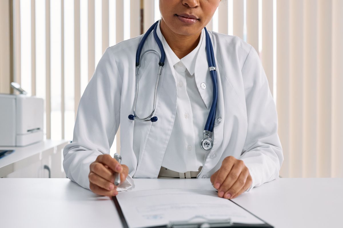 A doctor with a stethoscope recording patient details, representing a health check that needs to actually verify the right thing at every layer