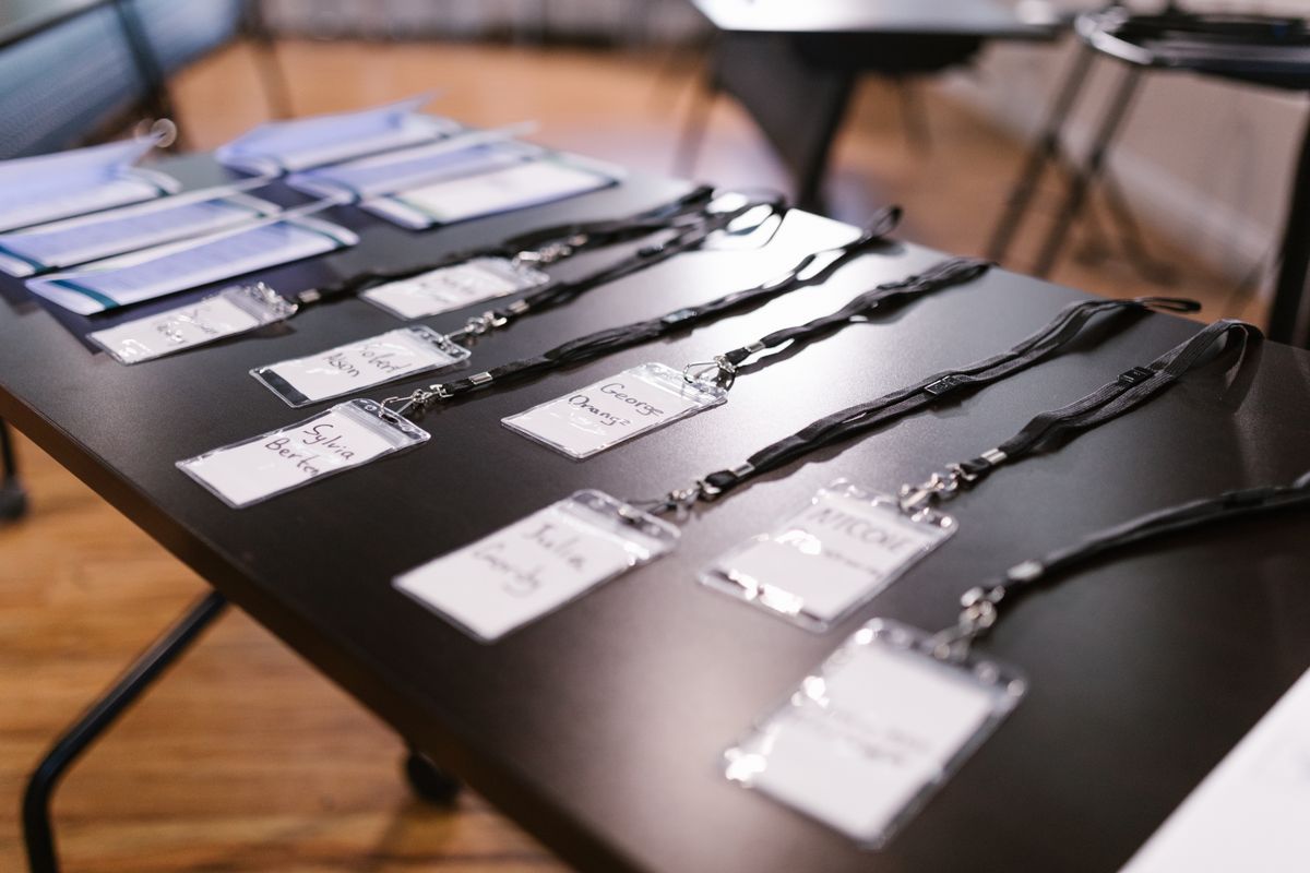 Name tags and folders neatly laid out for a conference, representing the queue name that has to match exactly between the producer adding jobs and the worker listening for them