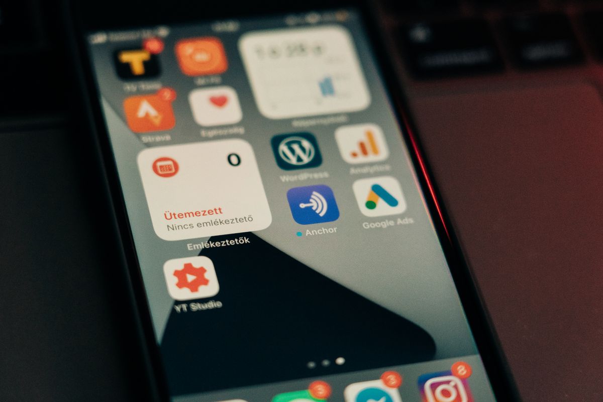 Outgoing webhook delivery system architecture — smartphone screen displaying notification icons representing event-based delivery