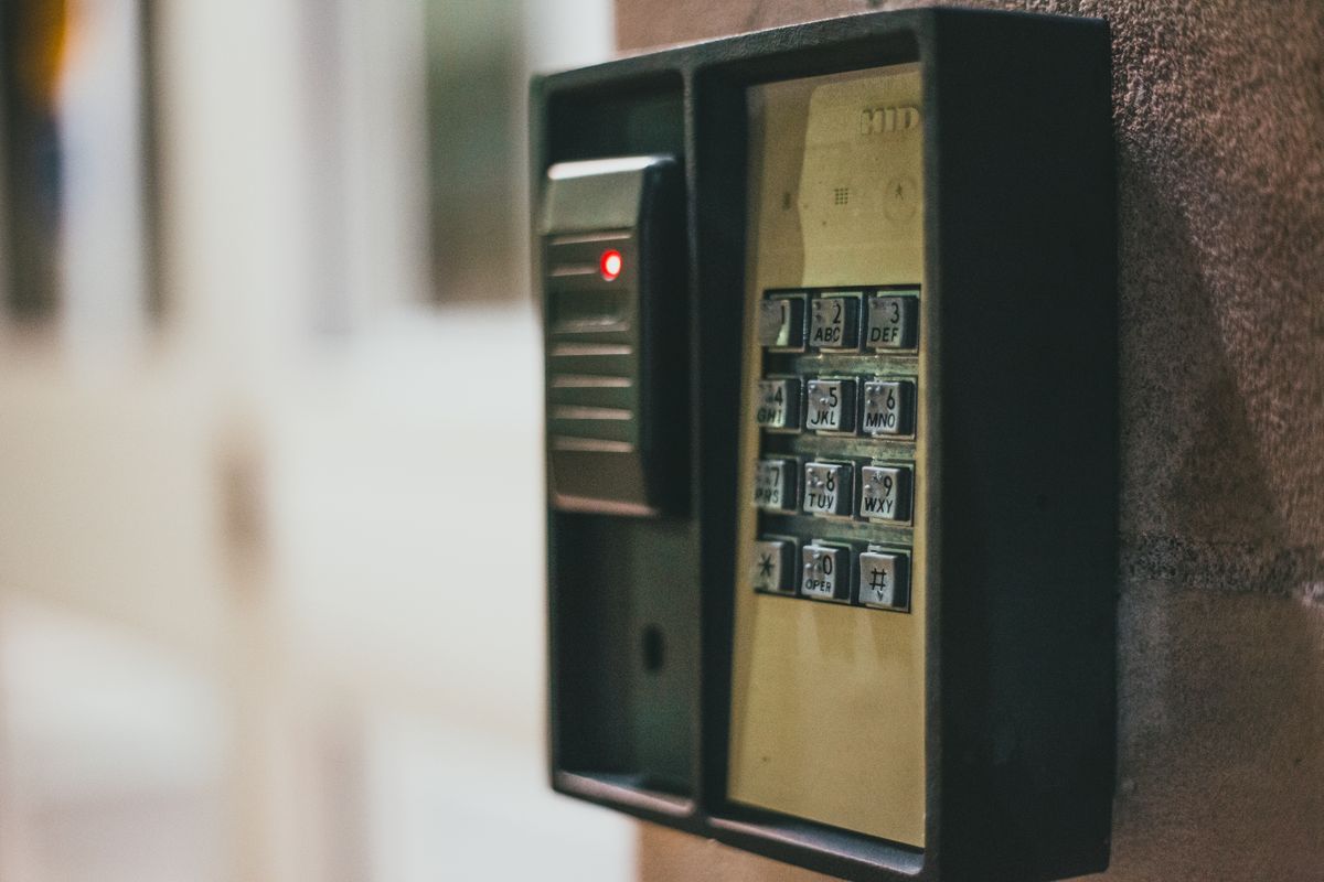 Workspace-level role permissions access control concept — close-up of a security keypad representing granular access management