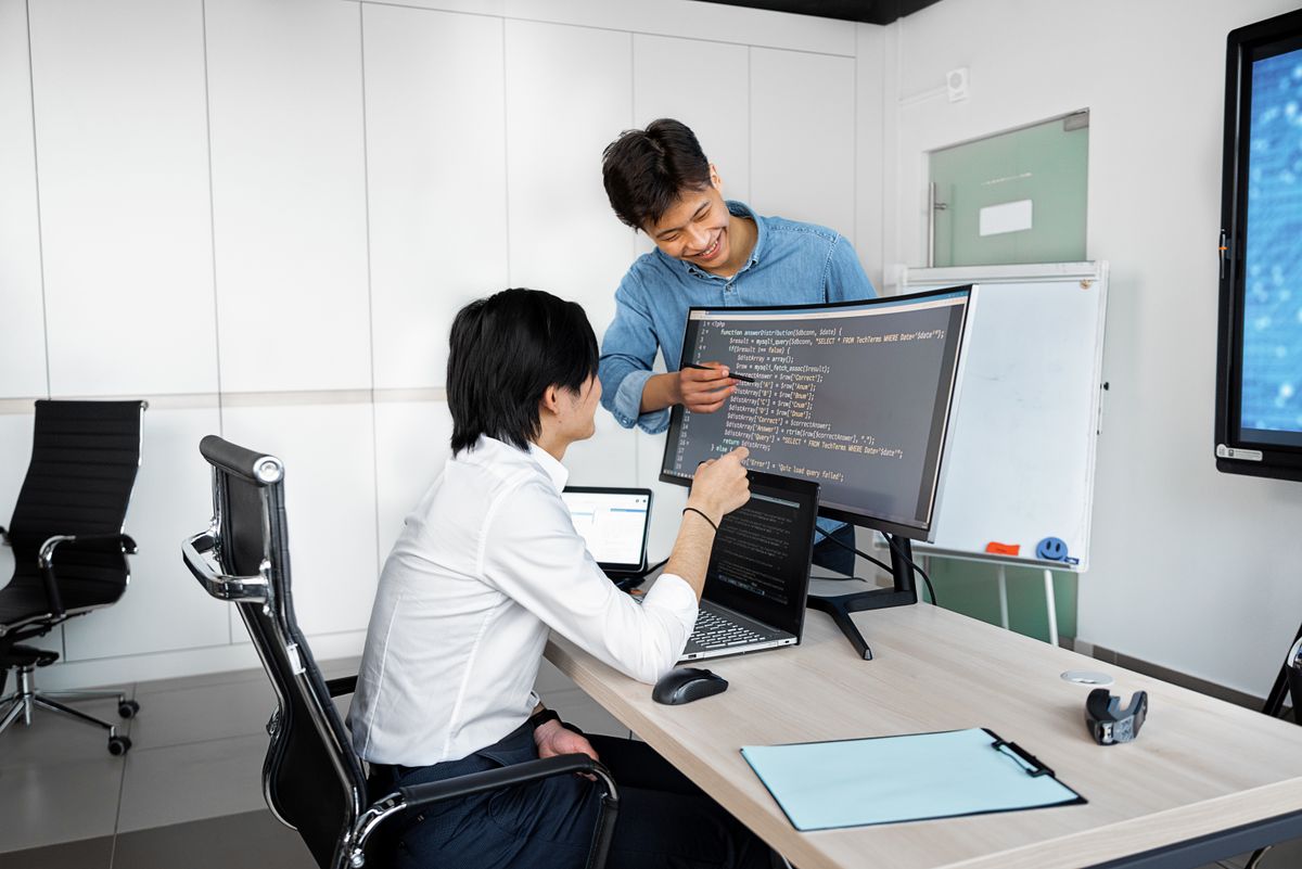 Developer portal and API key management for SaaS public API — programmers collaborating at desk representing developer experience