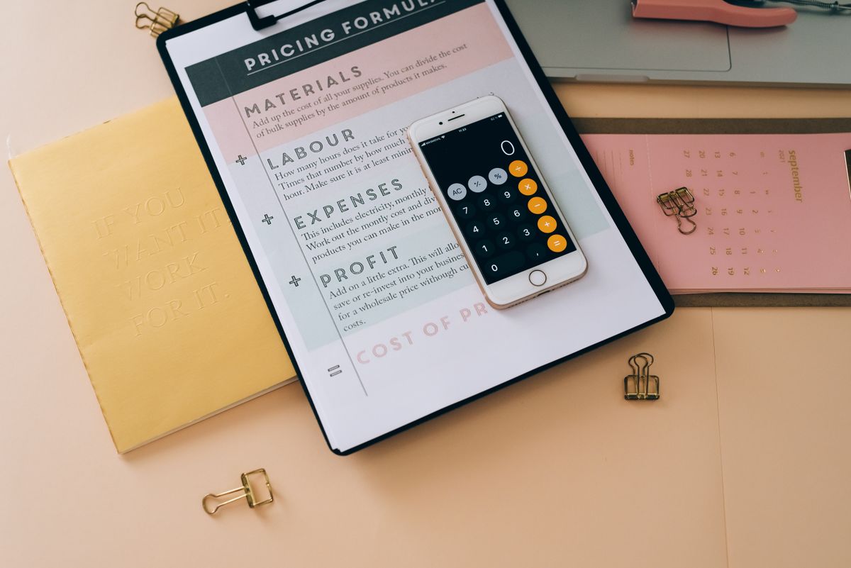 Organized billing and subscription management workspace with smartphone and documents
