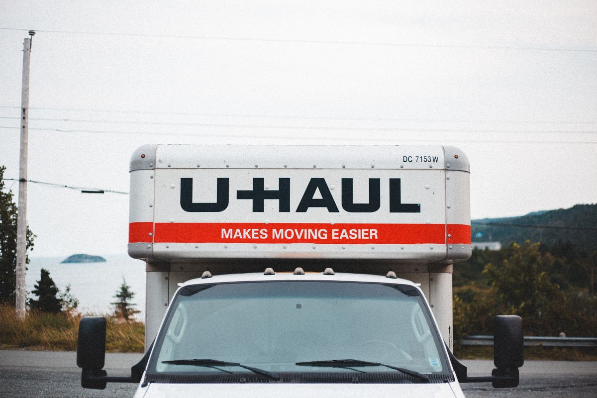 A U-Haul moving truck parked on a roadside, representing the migration from Cloudflare Pages to Cloudflare Workers that resolves the underlying adapter limitation